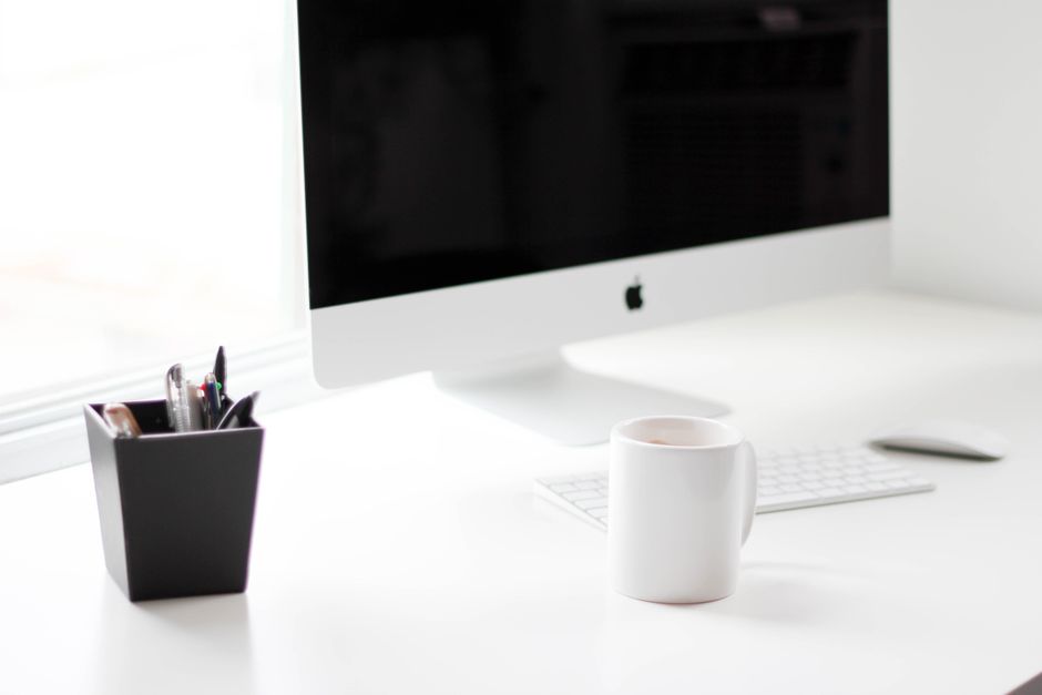 Clean desktop setup with a laptop, smartphone, and tablet in natural light